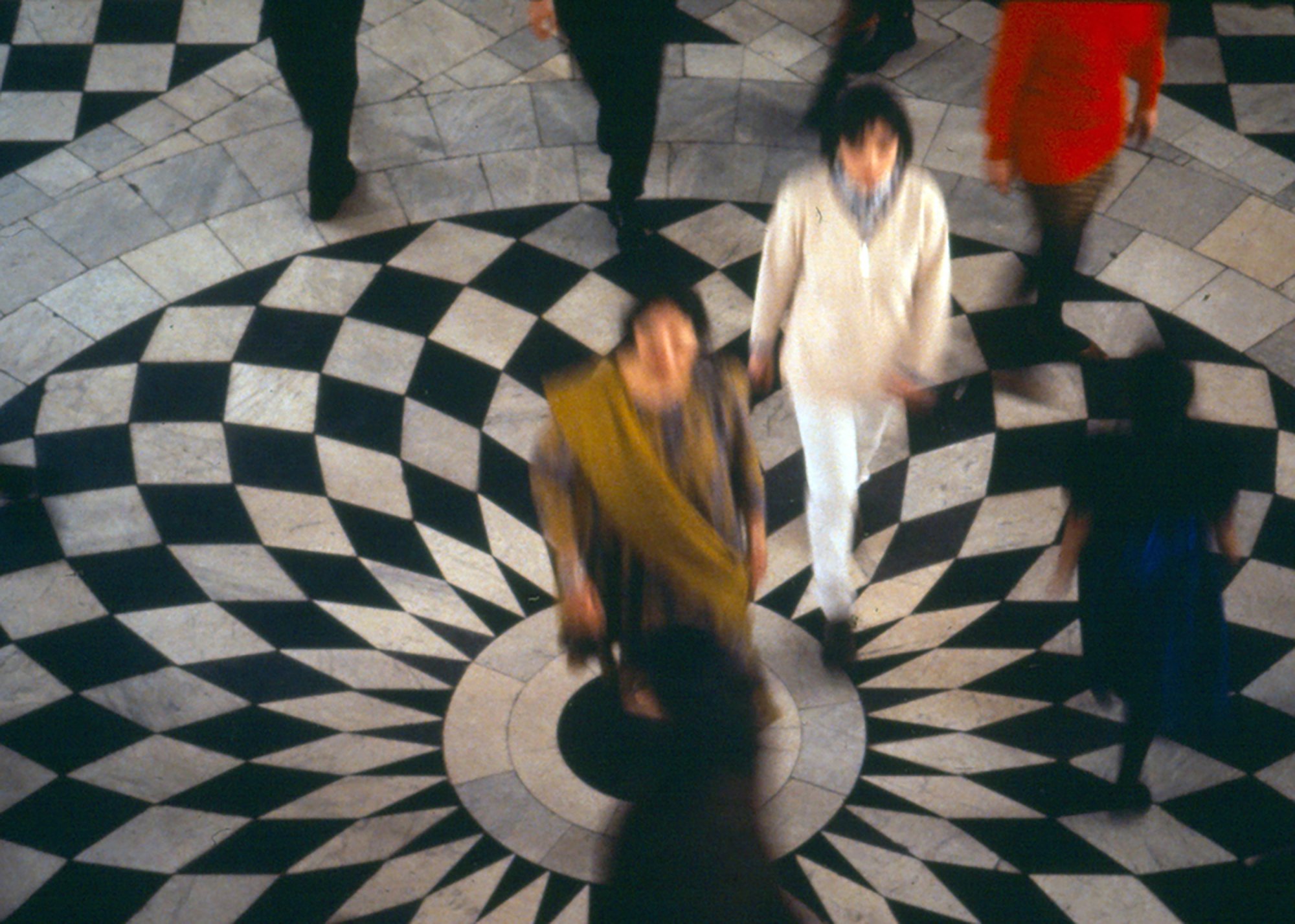Blurred performers appear above the graphic black and white patterned floor of the Great Hall of the Queen's House, Greenwich. Part of Tatsuo Miyajima's Clear Zero (1995). Photograph: Stephen White