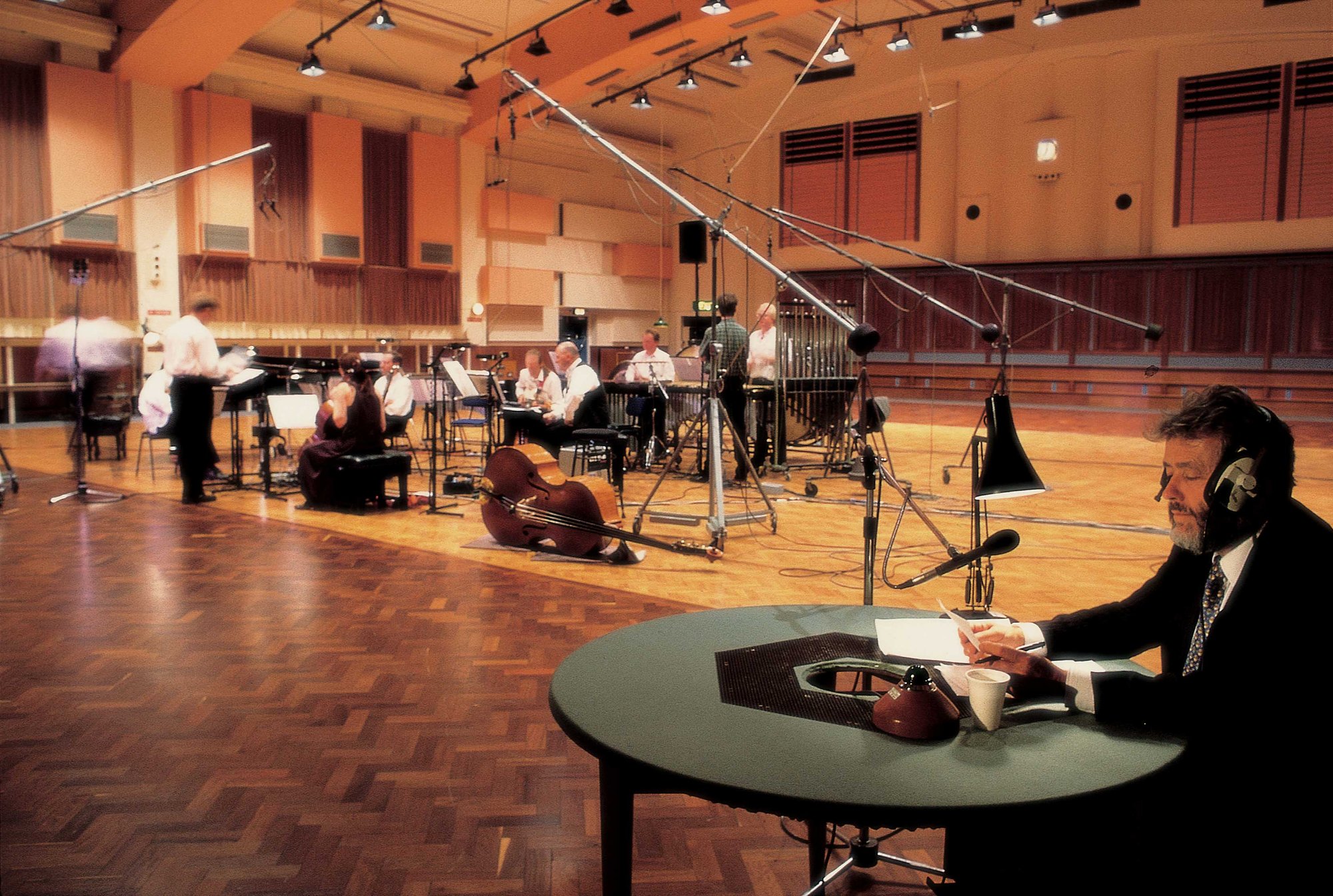 The Gavin Bryars Ensemble and broadcaster Peter Donaldson performing A Man in a Room, Gambling by Gavin Bryars and Juan Muñoz at the BBC Maida Vale Studios, London, 1997. Photograph: Steven White