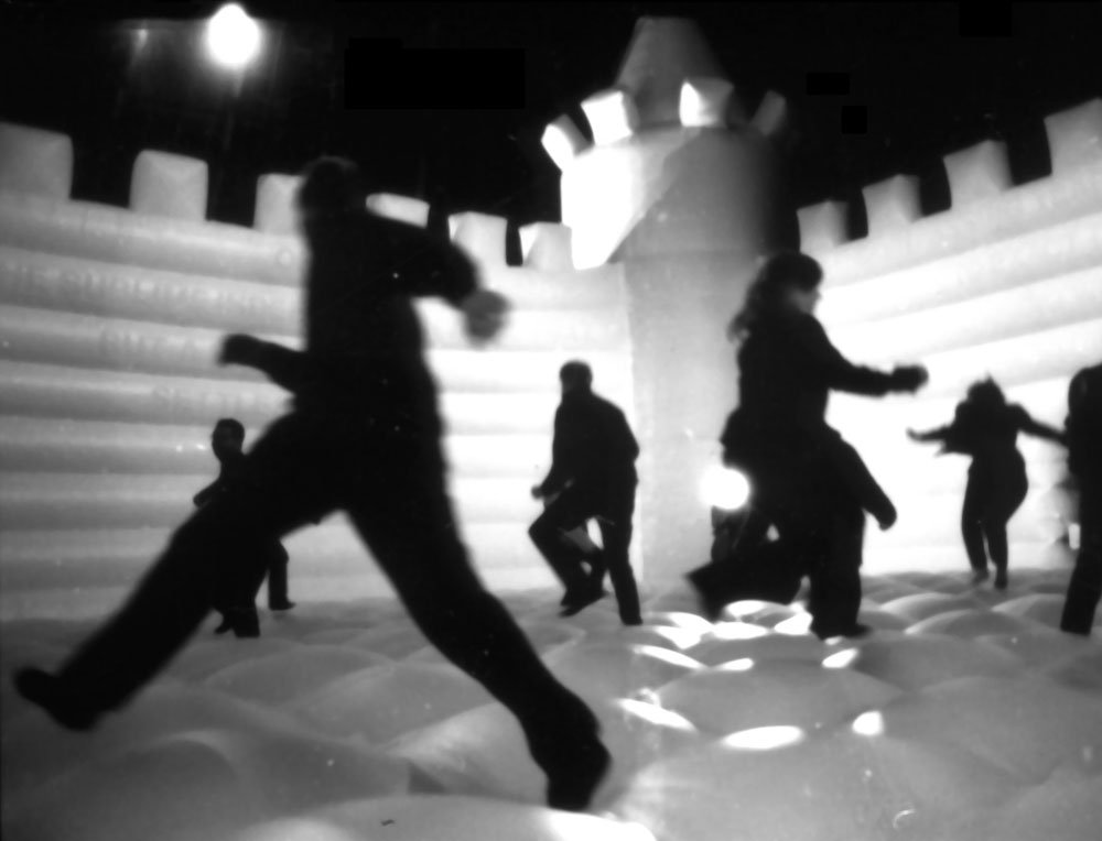 Audience members on bouncy castle, part of Tight Roaring Circle by William Forsythe, Dana Caspersen and Joel Ryan in The Roundhouse, London, 1997. Photograph: Sarah Ainslie