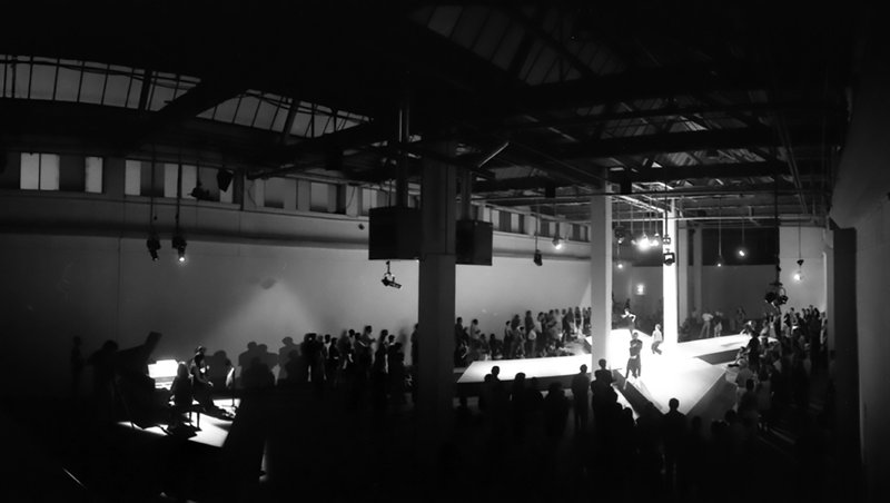 Image: The audience surroud the dancers as they perform under the lights of the Atlantis Building during 13 Different Keys, 1999. Photograph: Sarah Ainslie in Photograph: Sarah Ainslie