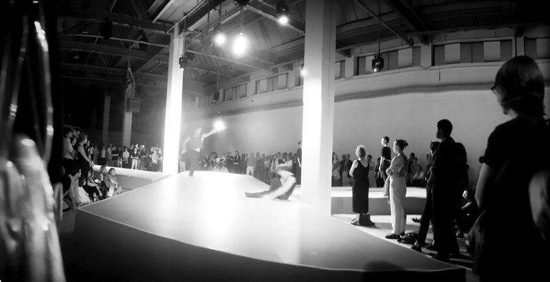Image: The audience surroud the dancers as they perform under the streaming lights of the Atlantis Building during 13 Different Keys, 1999. Photograph: Sarah Ainslie in Photograph: Sarah Ainslie