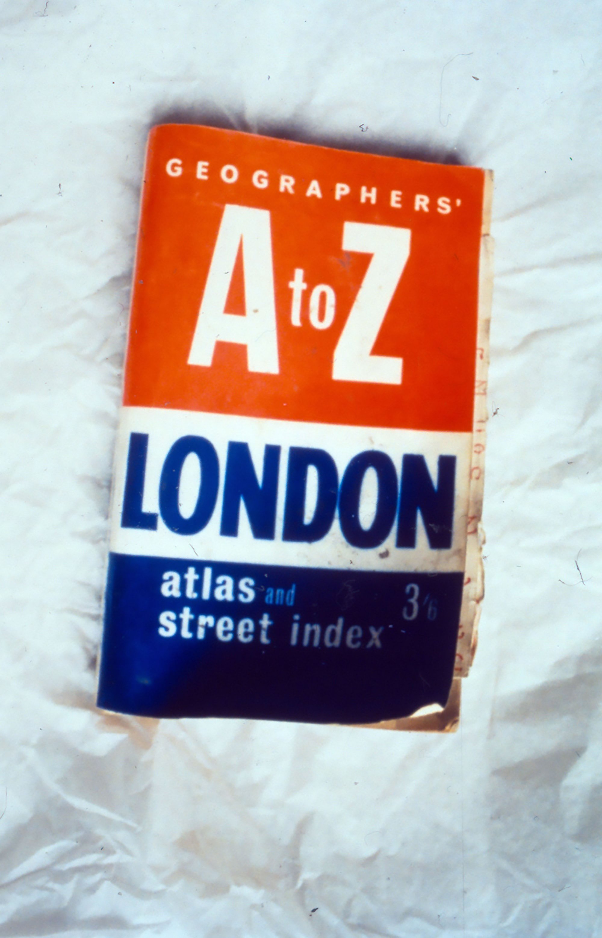 Image: Detail of a tattered red, white and blue London A-Z stuffed with loose pages of notes, an item found amongst Rodinsky's belongings. Photograph: Rachel Lichtenstein
