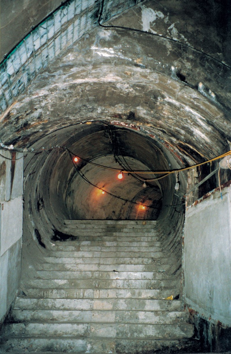 Steps in the disused Strand tube station, lit by a string of lights, lead to a tunnel, which curves away into the distance. This was the setting for The Vertical Line (1999) by John Berger and Simon McBurney.