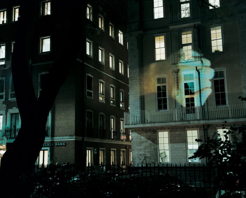 Image: A hand projected onto a building during The Influence Machine in Soho Square, 2000. Photograph: Dennis Cowley