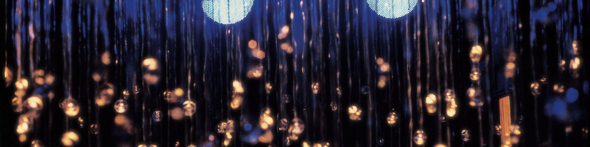 Image: Detail shot of the numerous speakers suspended from the ceiing at different heights, glistening in the glow of the three orbs floating in the blue light,at The Chapel during Witness, 2000. Photograph: Parisa Tagwizadin