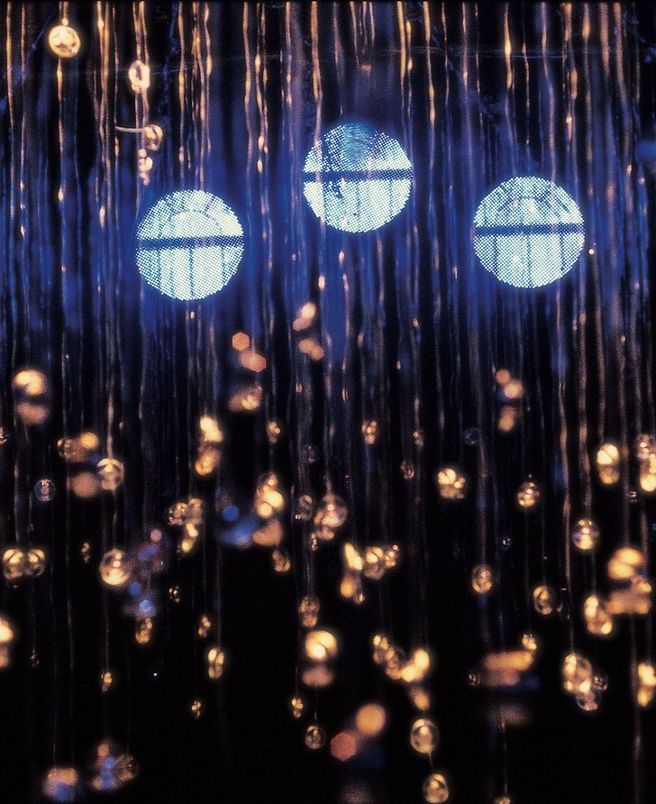 Image: Detail shot of the numerous speakers suspended from the ceiing at different heights, glistening in the glow of the three orbs floating in the blue light,at The Chapel during Witness, 2000. Photograph: Parisa Tagwizadin