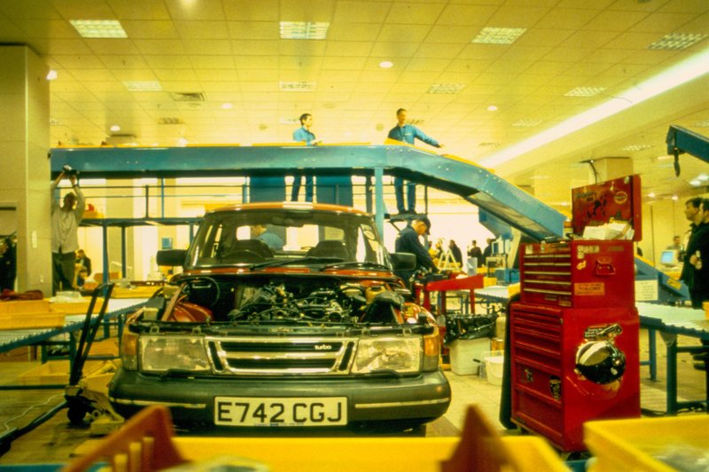 Image: In the background, Michael Landy oversees an operative, his cherry red Saab situated in the centre of the factory line at the defunct Oxford Street C&A store during Break Down, 2001. Photograph: Parisa Taghizadeh