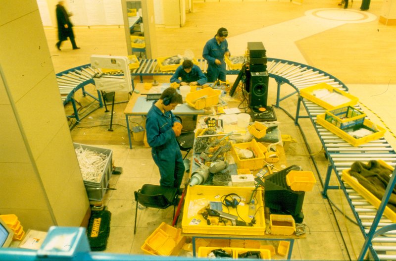 Image: Operatives on the factory line, dismantle various electrical goods, including a stereo system, during Break Down, 2001. Photograph: Parisa Taghizadeh