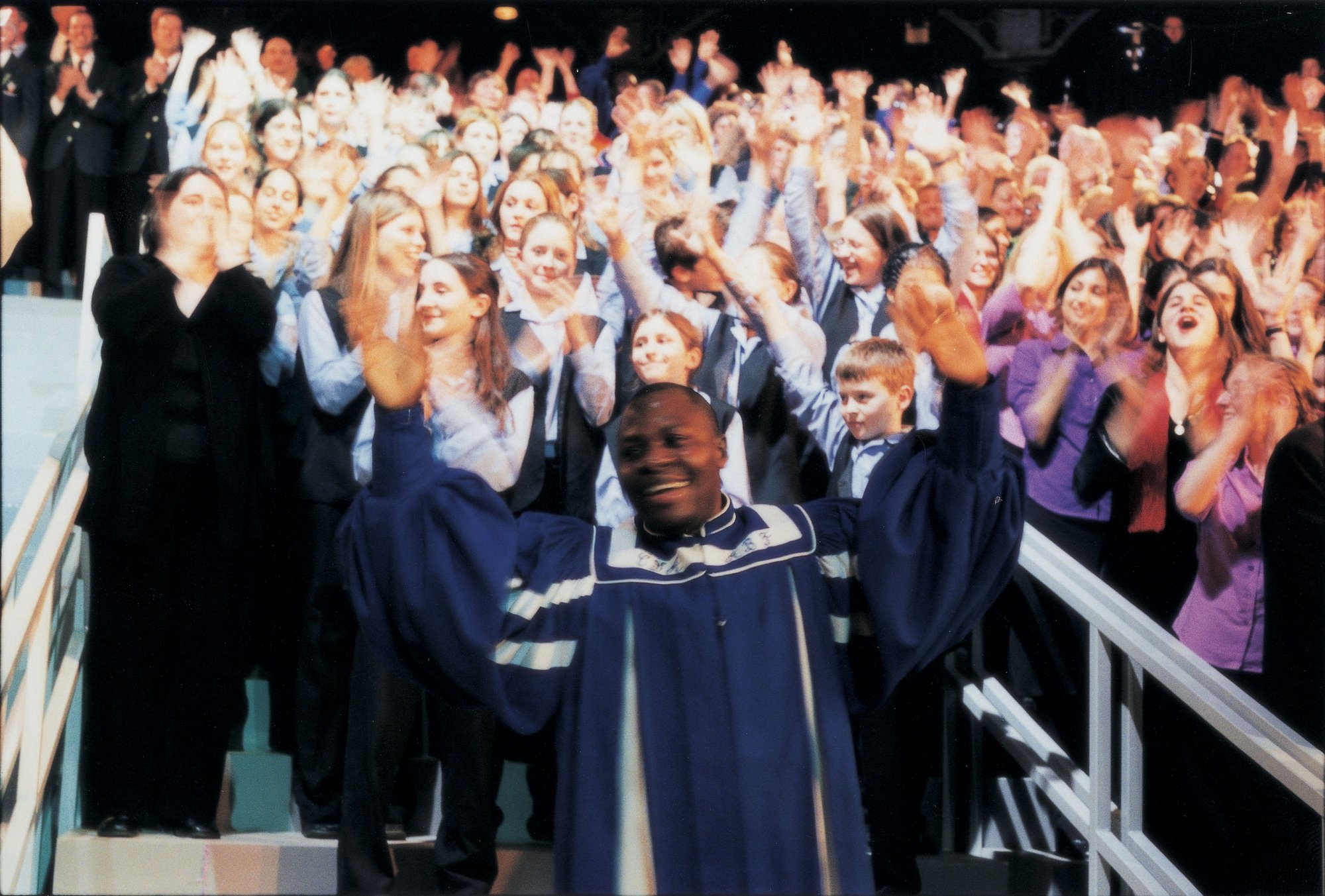 Image: The choirs perform during the Roundhouse performance of Because I Sing, 31 March, 2001. Photograph: Phil Lea