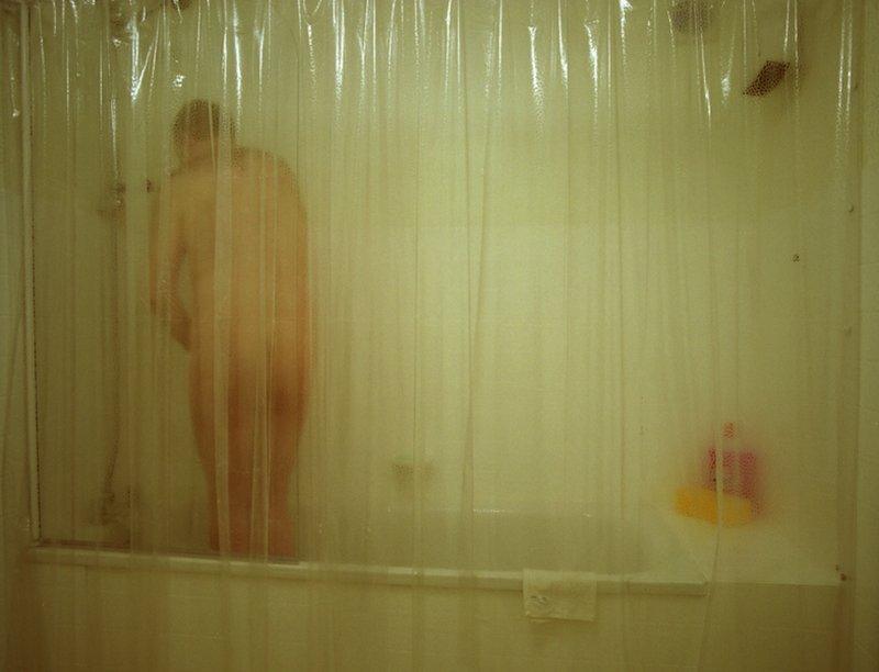 A man engaged in a stark and lonely act of masturbation in a shower at one of the Walden Street houses during Die Familie Schneider, 2004.