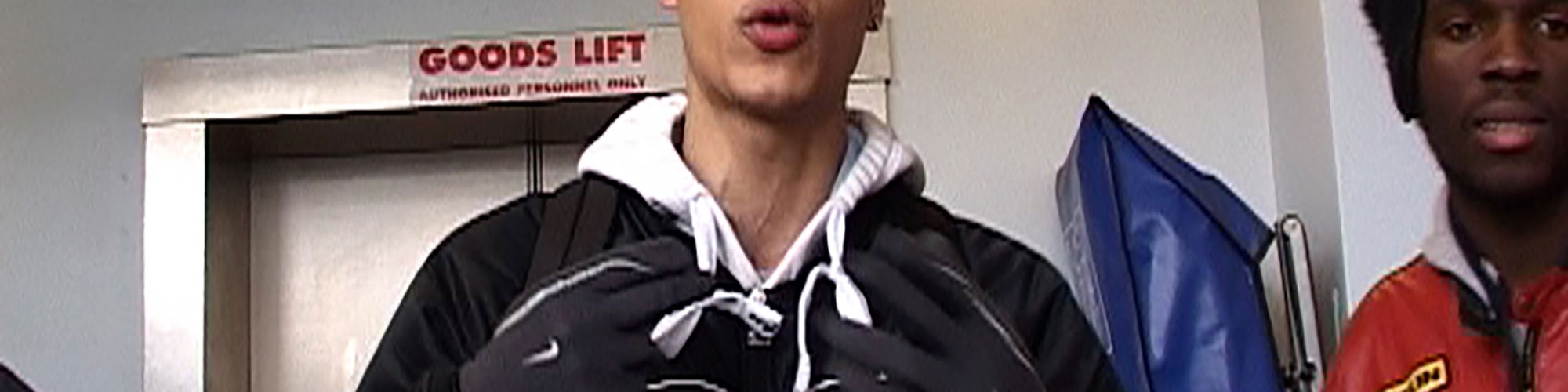 A young man wearing a baseball cap stands in front of a lift. MCs performing for Radio Nights, 2005. Photograph: David Blandy