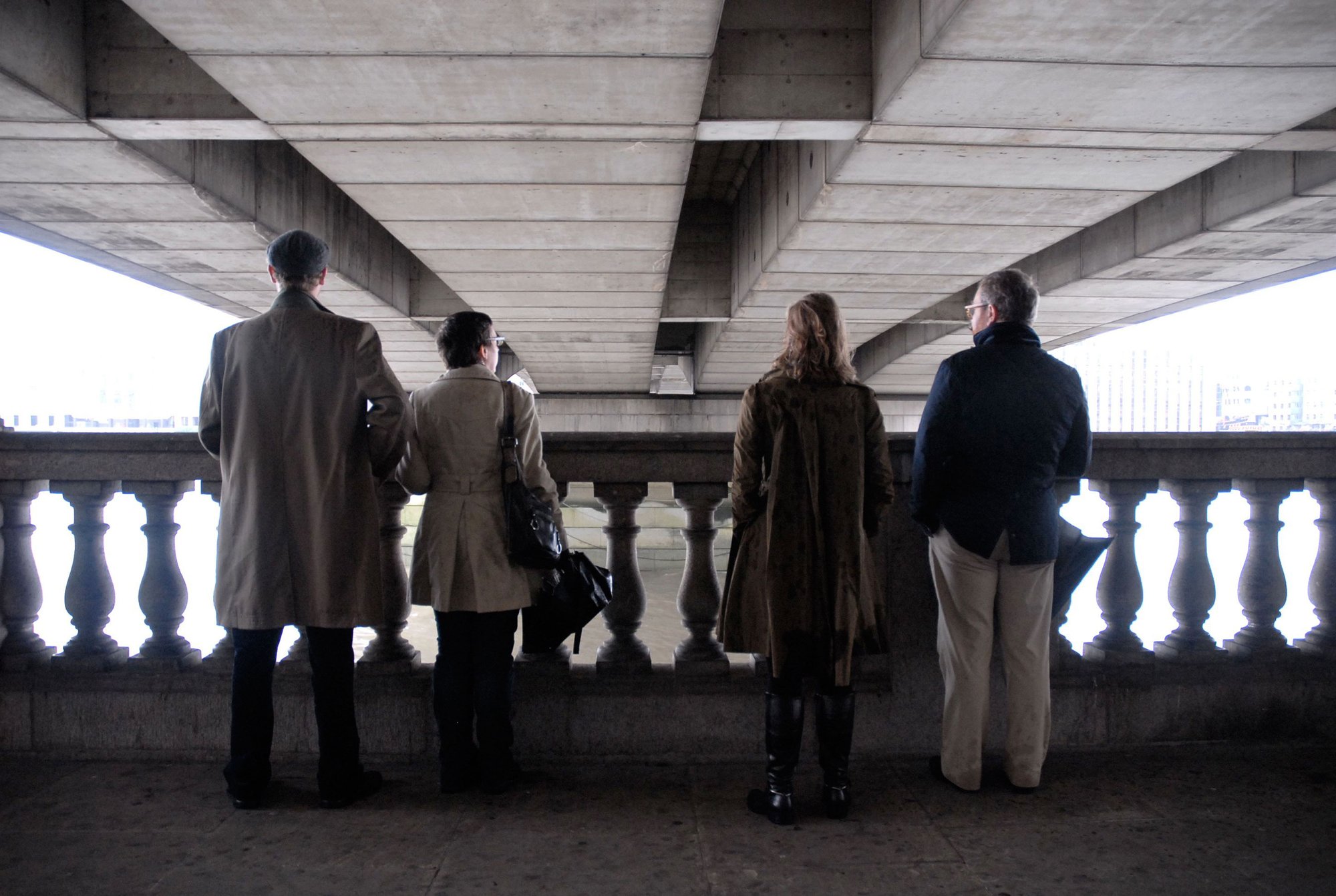 Image: Two couples stand underneath listening to SURROUND ME, London Bridge, 5 October 2010. Photograph:Bec Garland