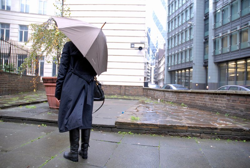 Image: A person with an umbrella listening to SURROUND ME, 5 October 2010. Photograph:Bec Garland