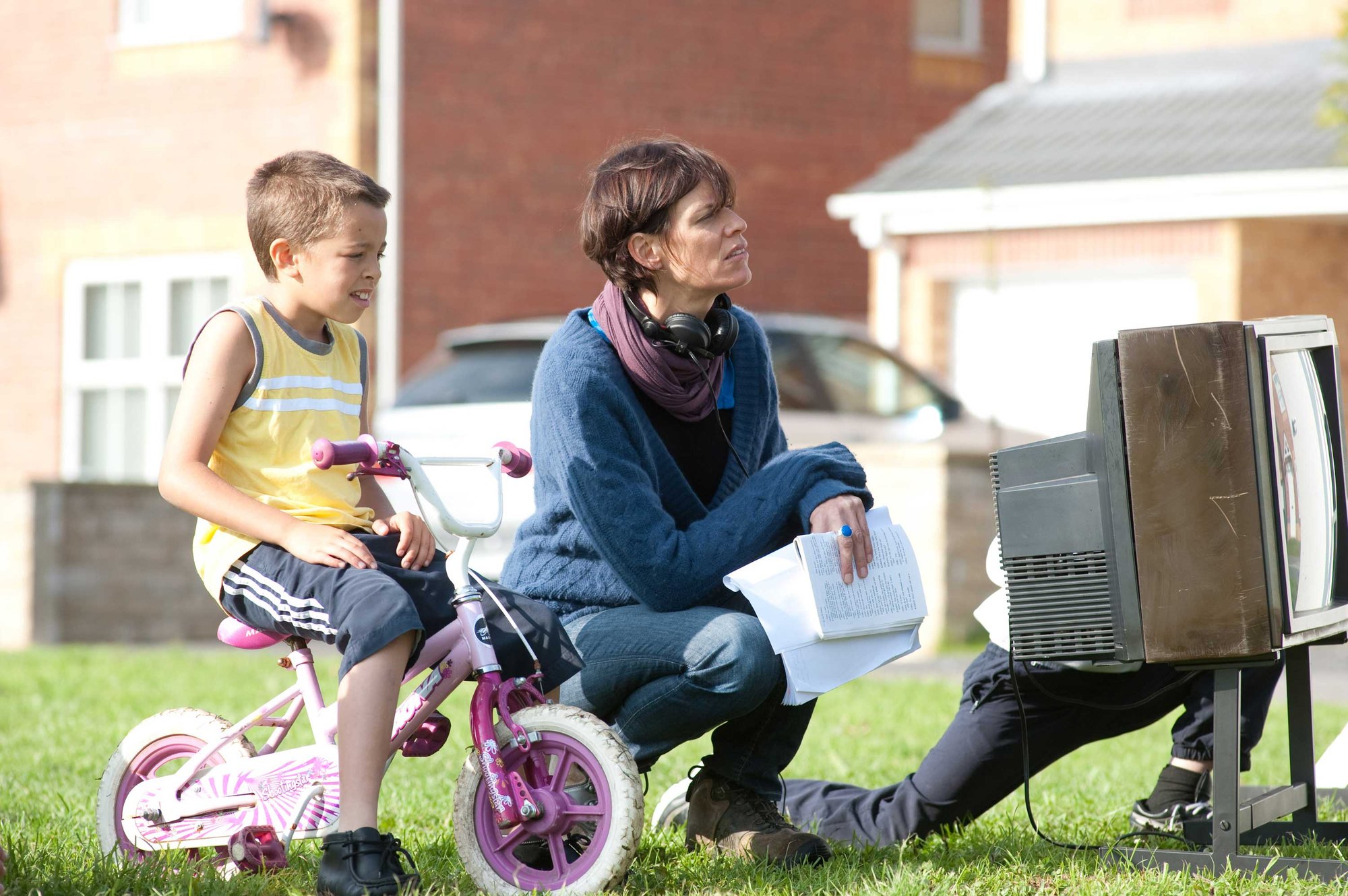 Director, Clio Barnard, watches a scene from Andrea Dunbar’s play,‘The Arbor’ being performed on Brafferton Arbor, with a young resident. Photograph: Nick Wall