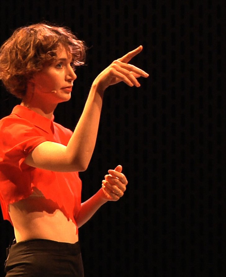 Miranda July in a performance still from New Society

NOTE THIS IS A VIDEO STILL FROM A RECORDING OF ANOTHER PERFORMANCE OF THIS WORK, NOT THE 2014 PERFORMANCE AT SADLERS WELLS, LONDON 