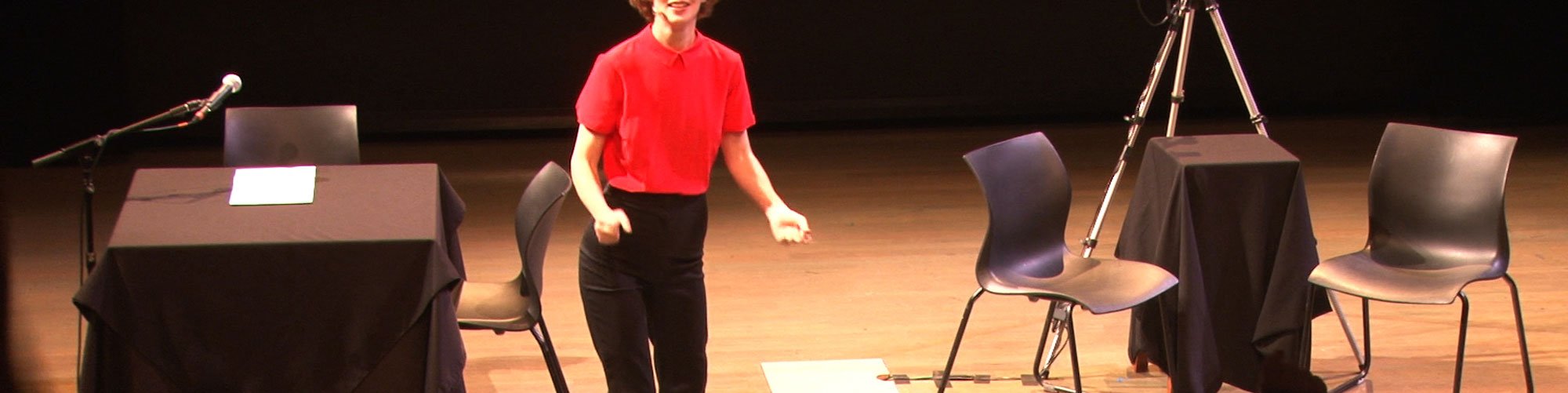 Miranda July in a performance still from New Society

NOTE THIS IS A VIDEO STILL FROM A RECORDING OF ANOTHER PERFORMANCE OF THIS WORK, NOT THE 2014 PERFORMANCE AT SADLERS WELLS, LONDON 