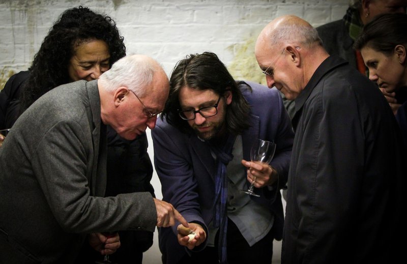 Andy Holden shows visitors a hand-painted porcelain egg, part of his sculptural installation 'How the Artist Was Led to the Study of Nature' (2017). Photograph: Liam White, 12 October 2017