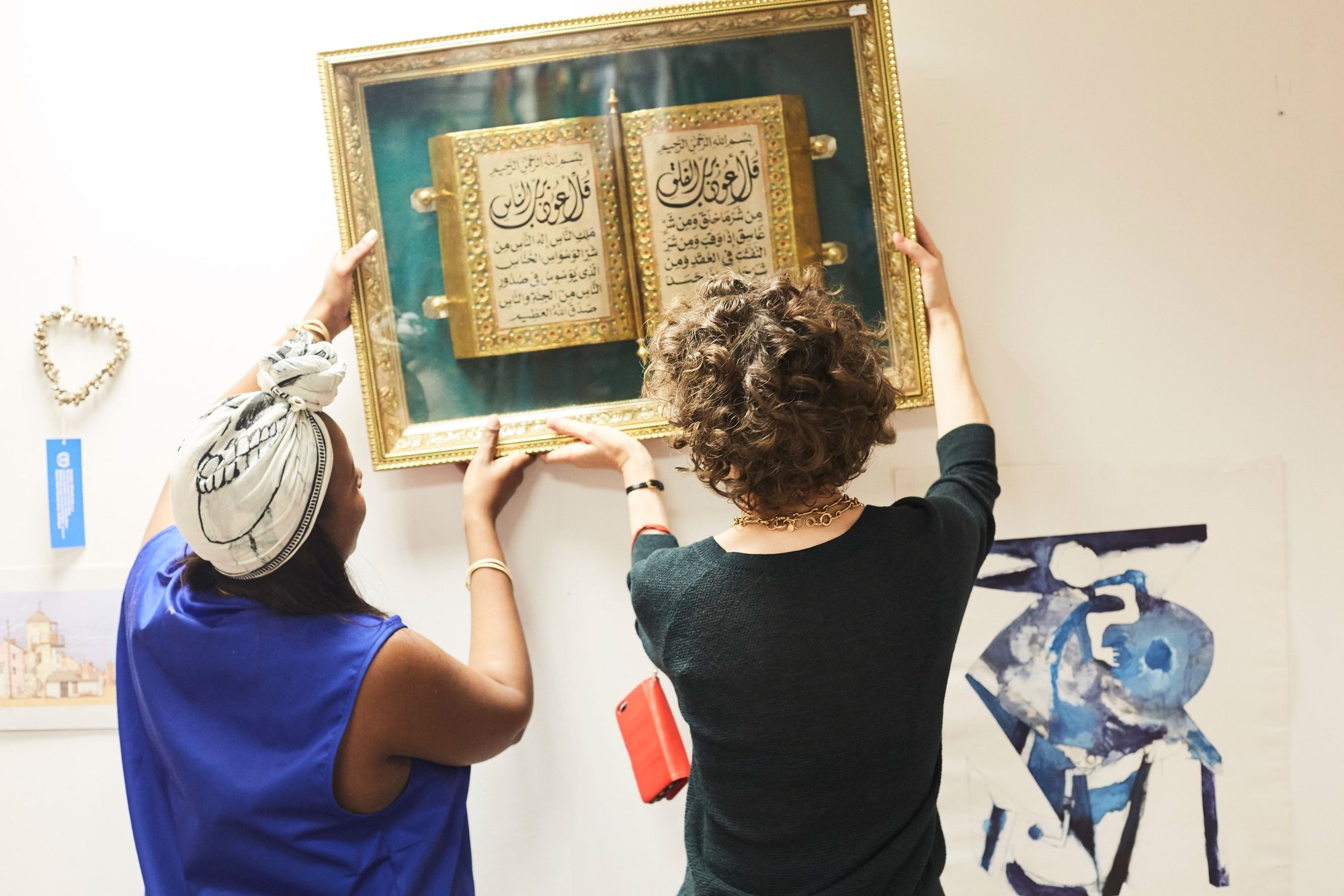 Shop manager Diana Ngonyama and Miranda July adjust a wall display, 31 August 2017. Photograph: Matthew Andrews