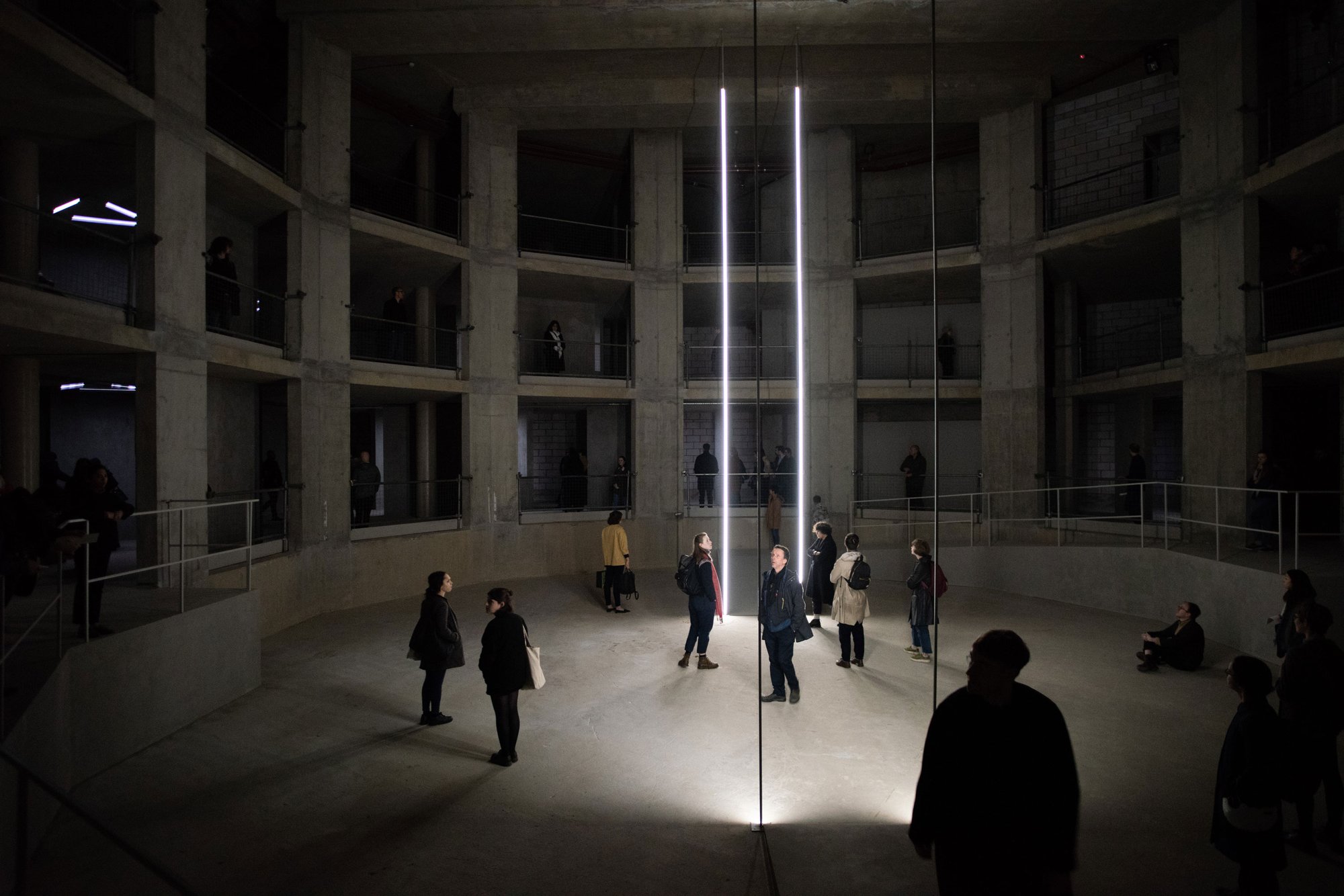 Visitors in the subterranean, concrete opera house Artangel used for the London edition of Taryn Simon's An Occupation of Loss, 2018. Photo: Hugo Glendinning