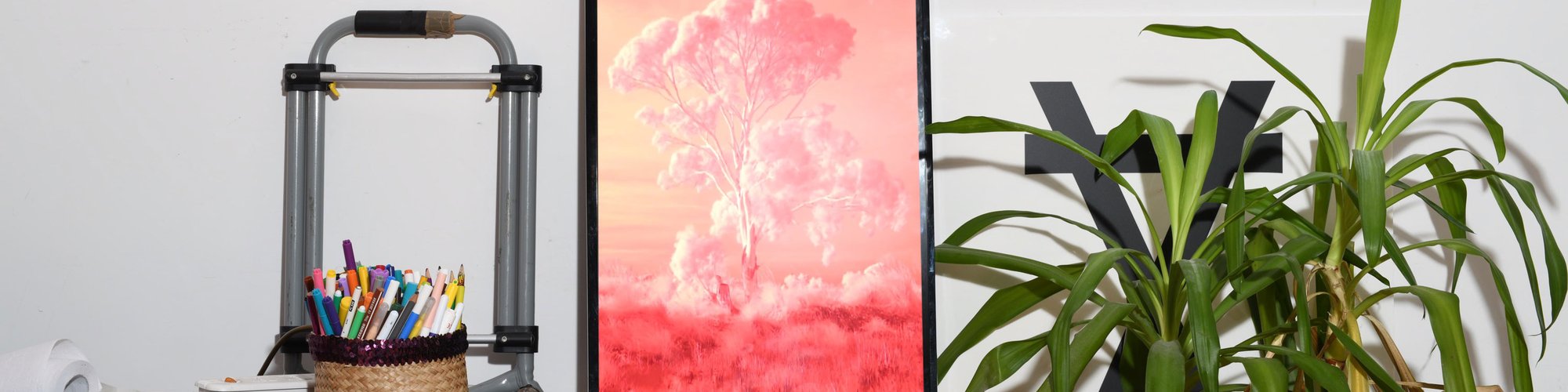 Red Lines displayed in a home next to plants and colouring pencils. Photograph: Tobias Faisst. Compositing: Tom Hadley