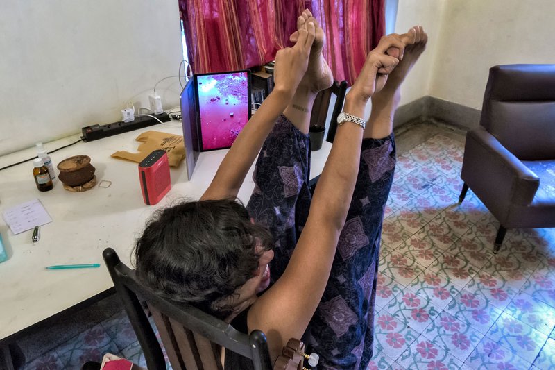 Veda Aggarwal at home with Evan Roth’s Red Lines in Calcutta, India. Photograph: Jhinku Banerjee.