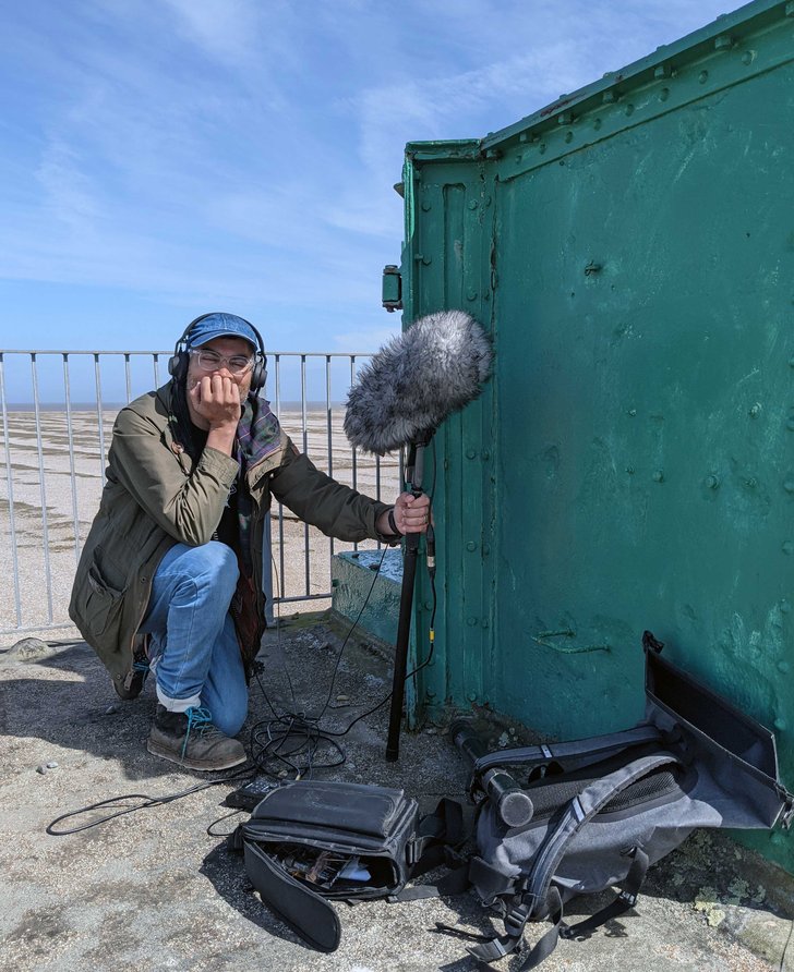 Brian d'Souza recording sound on Orford Ness, 2021. Photograph: Dan Spinney