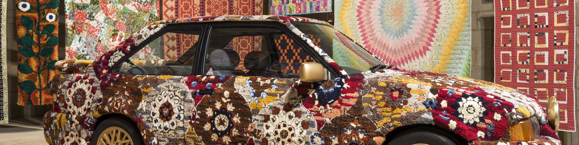 Hetain Patel, Somerset Road, 2024, installed next to quilts and carpets by hobbyists at Come As You Really Are. Photography by Thierry Bal.