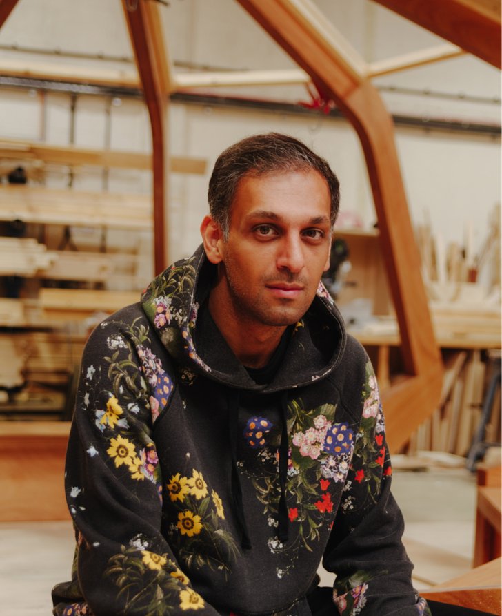 Portrait of artist Abbas Zahedi wearing black hoodie with floral print.